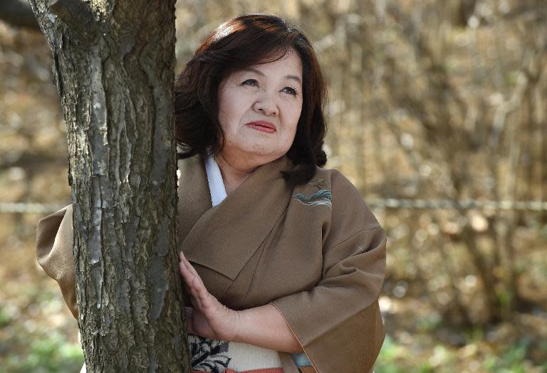 Yasue Tomita, 61, poses for a photographer as she makes her debut as a porn actress in Tsurugashima, Saitama prefecture
