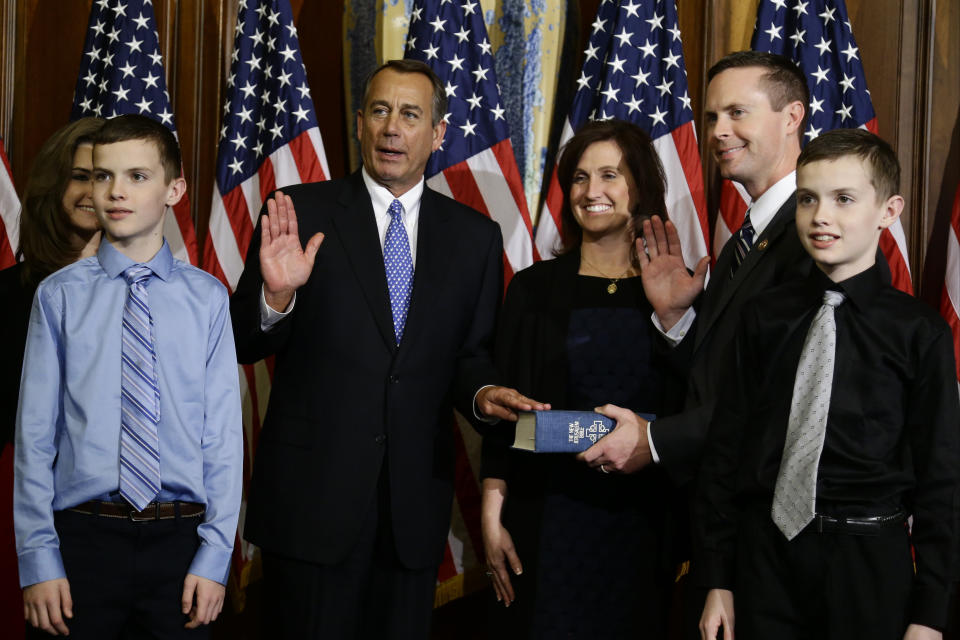 House Speaker John Boehner of Ohio performs a mock swearing in for Rep. Rodney Davis, R-Ill., Thursday, Jan. 3, 2013, on Capitol Hill in Washington, as the 113th Congress began. (AP Photo/Charles Dharapak) 