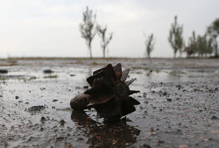 The remains of a piece of ammunition is seen on the road near Savur-Mohyla, a hill east of the city of Donetsk, August 28, 2014. REUTERS/Maxim Shemetov