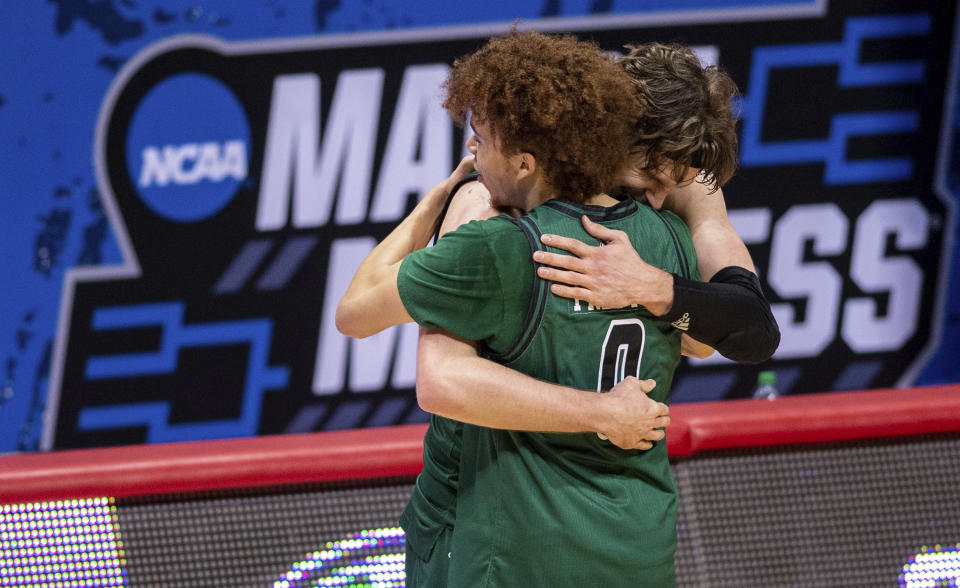 Ohio guard Jason Preston (0) and forward Ben Vander Plas (5) celebrate their defeat of Virginia. (AP Photo/Doug McSchooler)