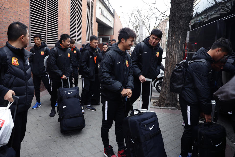 Players of the Chinese Super League team Wuhan Zall arrive at the Atocha train station in Madrid, Spain, Saturday, Feb. 29, 2020. The Chinese first-division soccer club from the city of Wuhan enters its second month in Spain without knowing when it will be able to return home. . It hasn't been easy for the nearly 50 members of the Wuhan Zall squad, but on Sunday they will get some reprieve from their ordeal by attending the Spanish league "clasico" between Real Madrid and Barcelona at the Santiago Bernabeu Stadium in Madrid. (AP Photo/Manu Fernandez)