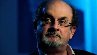 FILE PHOTO: British author Salman Rushdie listens during an interview with Reuters in London April 15, 2008.  REUTERS/Dylan Martinez/File Photo