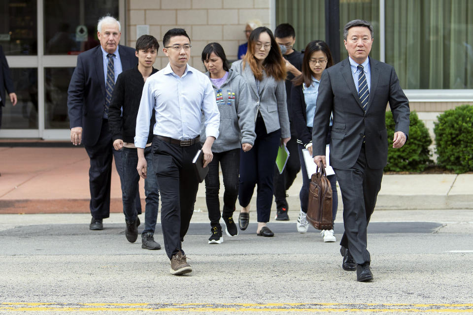 Members of visiting University of Illinois scholar Yingying Zhang's family walk with lawyers outside of the Federal Building and U.S. Courthouse Wednesday, June 12, 2019, in Peoria, Ill., before the trial of Brendt Christensen. (Stephen Haas/The News-Gazette via AP)