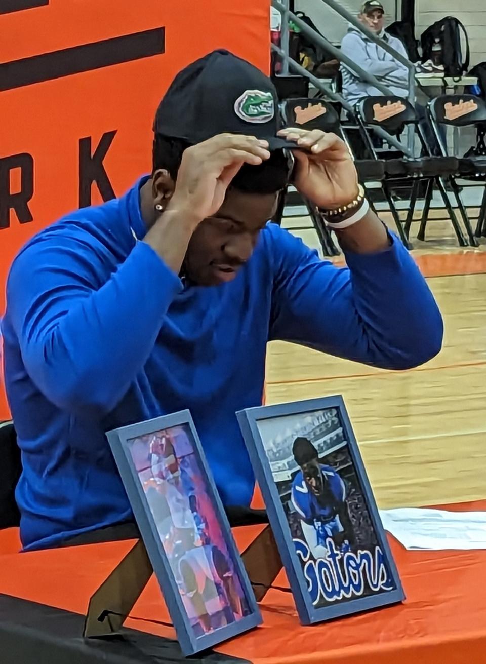 Orange Park offensive lineman Roderick Kearney dons a Gators cap after signing his letter of intent to play college football at the University of Florida on December 21, 2022. UF coach Billy Napier praised Kearney on Monday for his energy and passion in spring practice.