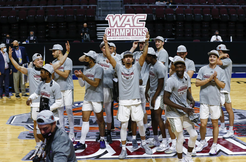 Grand Canyon players celebrate after defeating New Mexico State 74-56 in an NCAA college basketball game for the championship of the Western Athletic Conference men's tournament Saturday, March 13, 2021, in Las Vegas. (AP Photo/Chase Stevens)