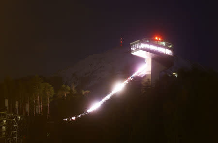 A long time exposure shows the ski jumping hill designed by Iraqi-British architect Zaha Hadid in Innsbruck, Austria March 31, 2016. REUTERS/Dominic Ebenbichler