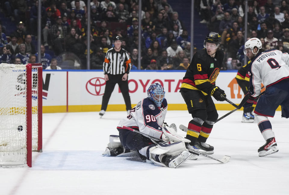 Vancouver Canucks' Brock Boeser (6) scores his second goal against Columbus Blue Jackets goalie Elvis Merzlikins, as Ivan Provorov (9) watches, during the third period of an NHL hockey game Saturday, Jan. 27, 2024, in Vancouver, British Columbia.(Darryl Dyck/The Canadian Press via AP)