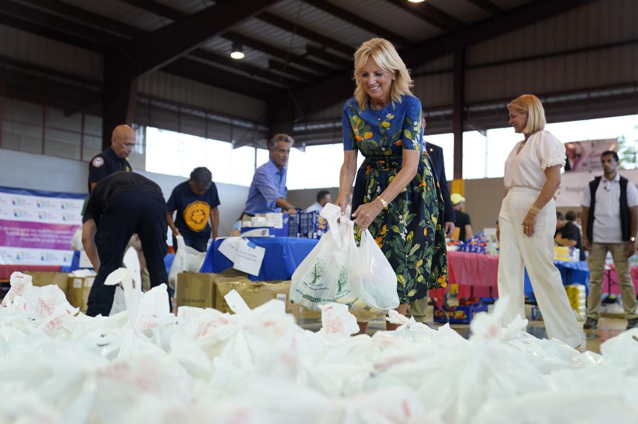 First Lady Jill Biden and others, fill and stack bags of supplies for Hurricane Fiona victims, Monday, Oct. 3, 2022, in Ponce, Puerto Rico, during a visit to Centro Sor Isolina Ferre Aguayo School. 