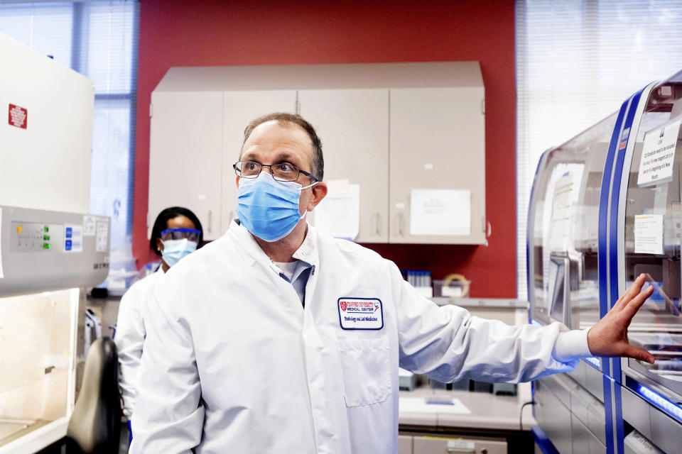 Dr. Benjamin Pinsky, medical director of the Stanford Clinical Virology Laboratory, explains how his lab processes upper respiratory samples from patients suspected of having COVID-19 on Wednesday, Feb. 3, 2021, in Palo Alto, Calif. Viruses mutate constantly. To stay ahead of the threat, scientists analyze samples for genetic changes, watching closely for ones that might make the virus more infectious or more deadly. (AP Photo/Noah Berger)