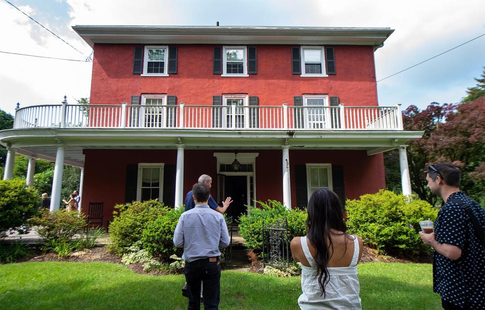Alexander Fraser, producing director of the Bucks County Playhouse, leads members of the Bucks County Playhouse cast of "Tick, Tick...Boom!", on a tour of the historic home of Oscar Hammerstein, in Doylestown, on Wednesday, June 28, 2023