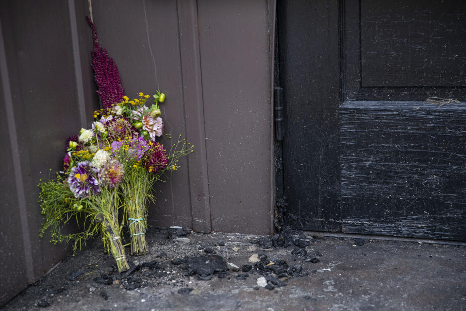 Flowers are left on the charred steps of the Adas Israel Synagogue Sunday September 15, 2019 in Duluth, Minn. A press conference was held on Sunday morning to discuss the findings of the investigation of the Adas Israel Synagogue fire that occurred early last week. A suspected was arrested last week and will be charged with first degree arson but there is no indication at this time that it was a hate crime. (Alex Kormann/Star Tribune via AP)