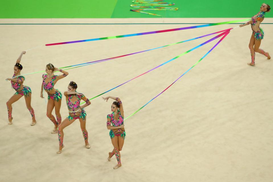 <p>Vera Biriukova, Anastasia Bliznyuk, Anastasiia Maksimova, Anastasiia Tatareva and Maria Tolkacheva of Russia compete during the Group All-Around Final on Day 16 of the Rio 2016 Olympic Games at Rio Olympic Arena on August 21, 2016 in Rio de Janeiro, Brazil. (Getty) </p>