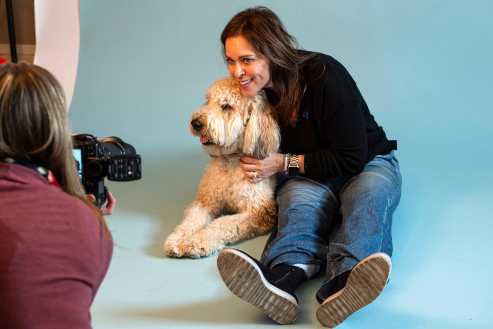 Elizabeth Marcus, of Needham, with her dog, Neiman Marcus, in front of the lens of Wayland-based photographer Brea Chislett, at We Dig Your Dog in Natick, Feb. 15, 2024.