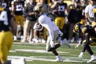 Purdue wide receiver David Bell (3) runs from Iowa defensive back Matt Hankins, right, after catching a pass during the first half of an NCAA college football game, Saturday, Oct. 16, 2021, in Iowa City, Iowa. (AP Photo/Charlie Neibergall)