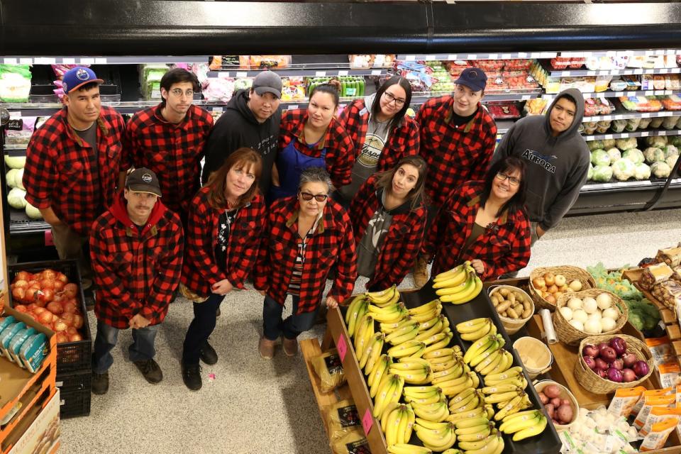 Employees at the market. Cathwyn Philpotts, bottom row, second from the left, says they've worked out the kinks since they opened the doors.