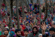 <p>Kashmiri villagers watch the funeral procession of Rayees Ahmed in Narapora, 55 Kilometers (35 miles) south of Srinagar, Indian controlled Kashmir Ahmed, died Wednesday in a hospital in Srinagar five days after he sustained gunshot wounds fired by Indian army soldiers that left two young men killed and nine others injured in a village in the disputed Himalayan region. (AP Photo/Dar Yasin) </p>