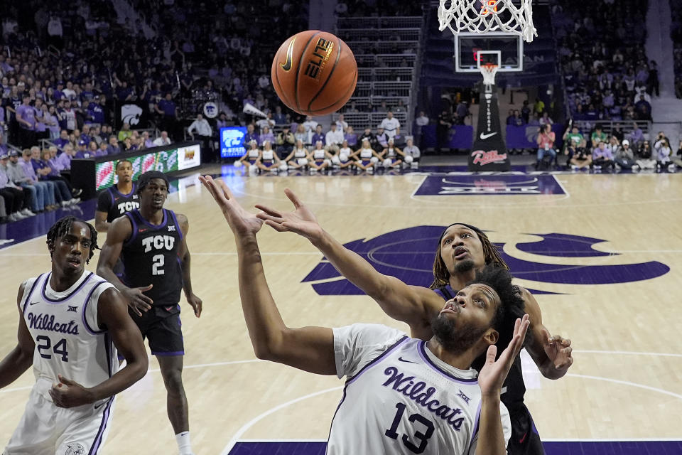 TCU forward Xavier Cork, back right, and Kansas State forward Will McNair Jr. (13) compete for a rebound during the first half of an NCAA college basketball game Saturday, Feb. 17, 2024, in Manhattan, Kan. (AP Photo/Charlie Riedel)