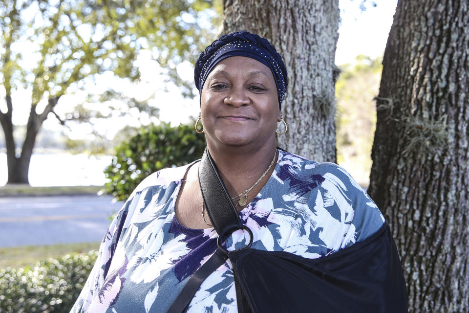 Vanessa Akinniyi poses front of her doctor's office in Jacksonville, Fla., Thursday, Jan. 13, 2022. Akinniyi was stuck in denial about diabetes until a care manager from her health insurer coaxed her out. The nurse fed Akinniyi information about her condition and talked about potential problems she could run into like vision loss. (AP Photo/Gary McCullough)