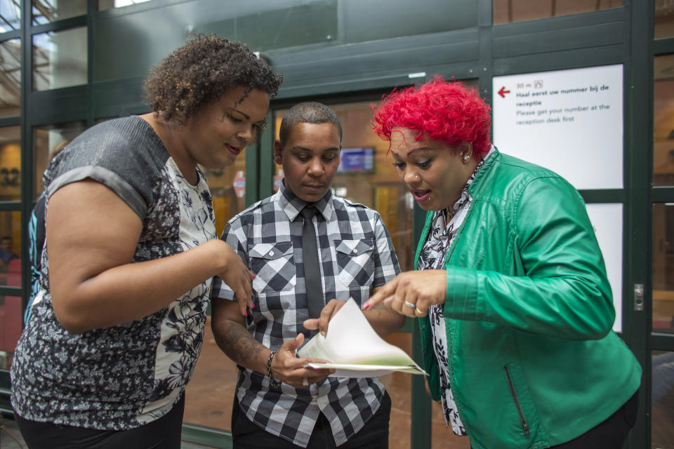 Damian Jackson (center), 51, shows family members his new documents after changing his officially registered gender from female to male at City Hall in Amsterdam, Netherlands, on July 1, 2014. Jackson was among the first to obtain new documents under a new law legalizing the registration of a transgender person's preferred gender in official state documents, including identity cards and passports. Under the previous law, a person had to face hormonal treatment, surgery or sterilization before any change in gender registration was allowed.