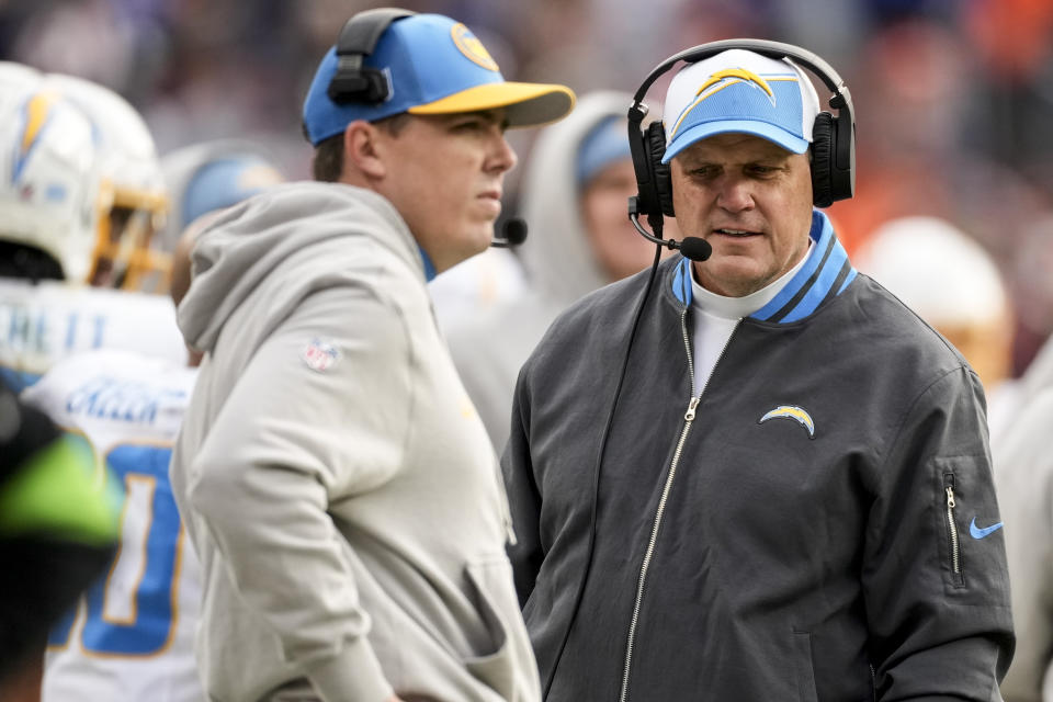 Los Angeles Chargers interim head coach Giff Smith, right, walks the sidelines during the first half of an NFL football game against the Denver Broncos, Sunday, Dec. 31, 2023, in Denver. (AP Photo/David Zalubowski)