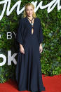 <p>in a black Chloé gown with a keyhole cutout, plus statement pendant necklace. </p>