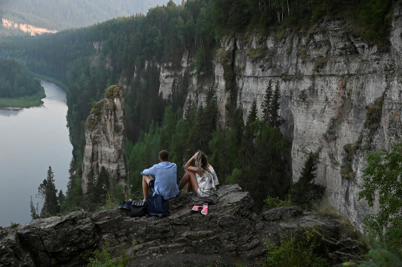 FILE PHOTO: Tourists enjoy the view from stone pillars on the bank of the Usva River in Perm Region