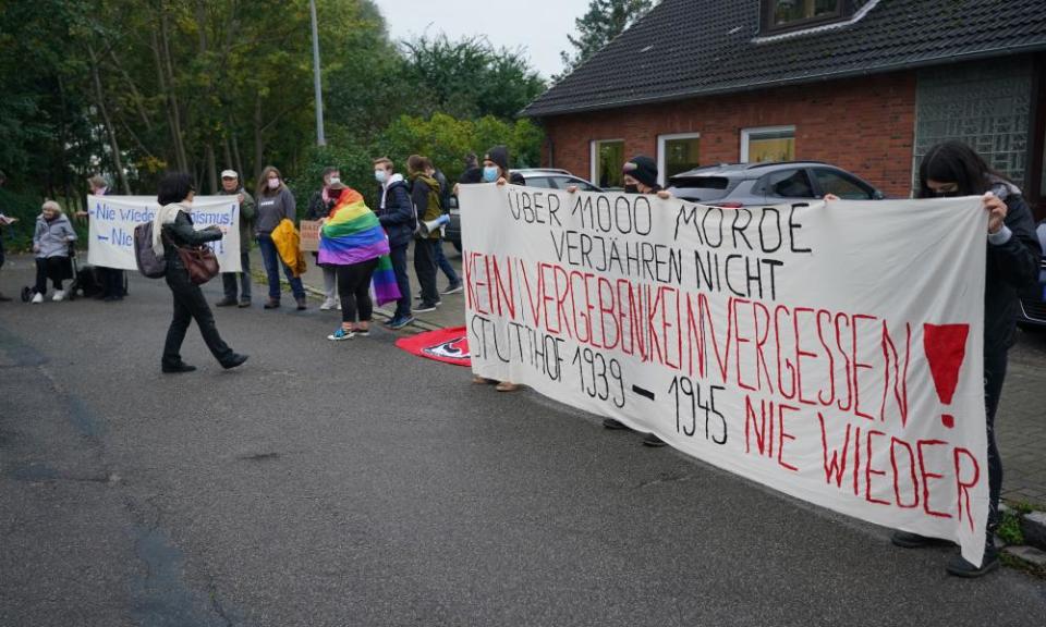 People protest with a banner reading ‘No forgiving! No forgetting!’