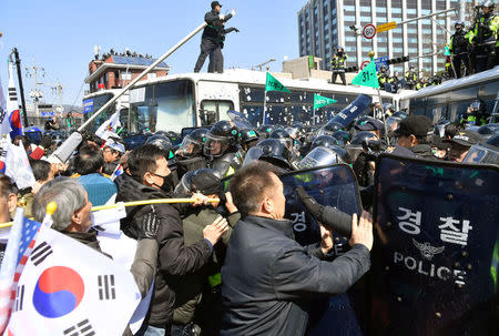 Protesters supporting South Korean President Park Geun-hye clash with riot policemen near the Constitutional Court in Seoul, South Korea, in this photo taken by Kyodo on March 10, 2017. Mandatory credit Kyodo/via REUTERS