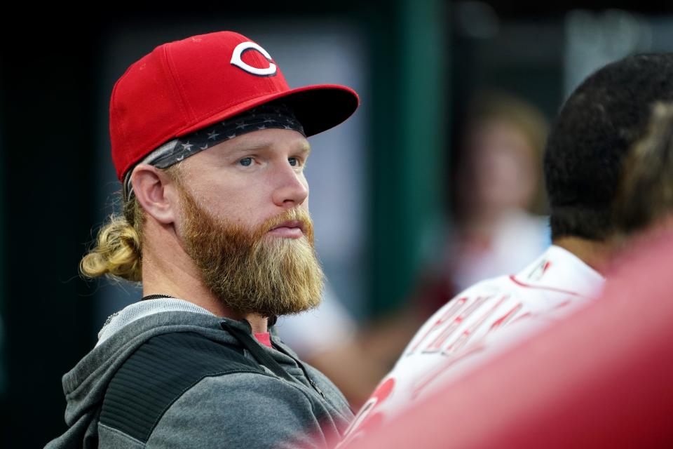 Cincinnati Reds outfielder Jake Fraley (27) sits in the dugout in the seventh inning during a baseball game against the Milwaukee Brewers, Friday, June 17, 2022, at Great American Ball Park in Cincinnati. 