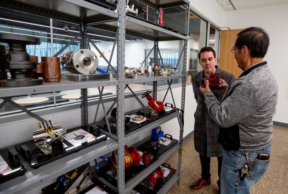 Republican Lea County commissioner Jonathan Sena, left, visits CTECH at Hobbs High School, which offers technical classes for students interested in entering the oil and gas industry. Sena looks on as teacher Gilbert Ramirez shows him equipment used for instruction.