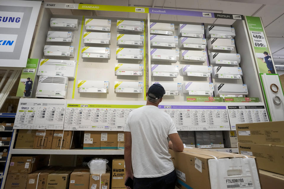 A man looks at a a wall displaying air conditioning models on sale at department store, in Rome, Tuesday, July 25, 2023. Rising global temperatures are elevating air conditioning from a luxury to a necessity in many parts of Europe, which long has had a conflictual relationship with energy-sucking cooling systems deemed by many a U.S. indulgence. (AP Photo/Andrew Medichini)