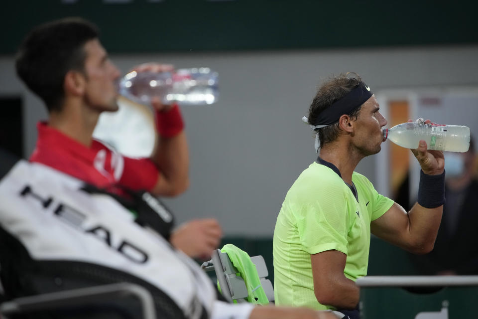 Spain's Rafael Nadal, right, and Serbia's Novak Djokovic drink during a break in their semifinal match of the French Open tennis tournament at the Roland Garros stadium Friday, June 11, 2021 in Paris. (AP Photo/Christophe Ena)