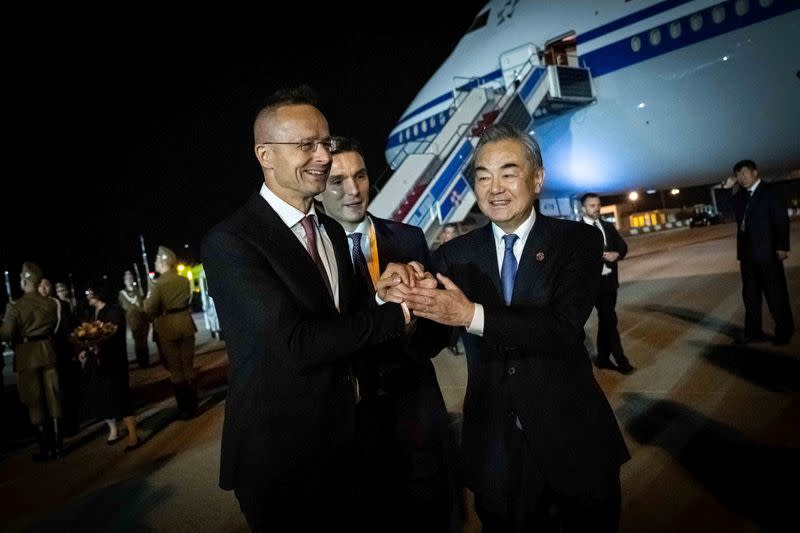 Hungarian Foreign and Trade Minister Szijjarto welcomes Chinese Foreign Minister Wang Yi at the Ferenc Liszt International Airport in Budapest