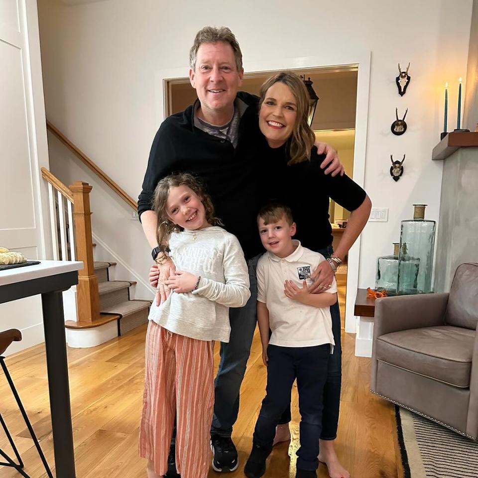 Savannah Guthrie stands in living room with family