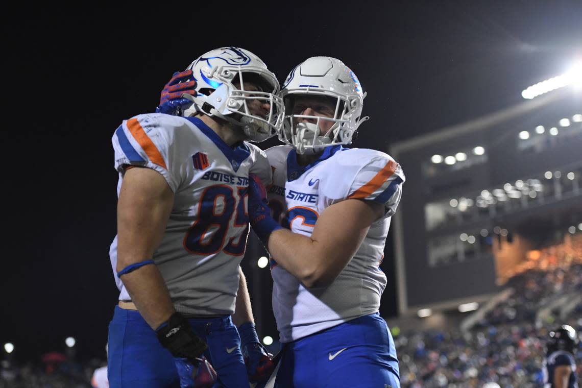 Boise State tight end Matt Lauter (85) celebrates with fellow tight end Austin Terry after one of Lauter’s two touchdown catches in the Broncos’ 42-14 win at Utah State on Saturday.