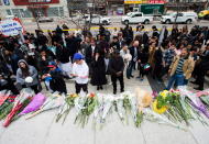 <p>People pay tribute at a memorial along Yonge Street, Tuesday, April 24, 2018, in Toronto, the day after a driver drove a van down sidewalks, striking and killing numerous pedestrians in his path. (Photo: Nathan Denette/The Canadian Press via AP) </p>