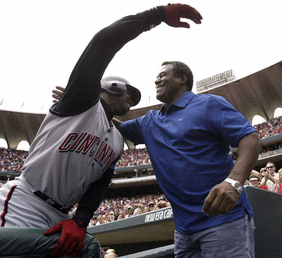 Griffey hugs his father after hitting his 500th home run. (Dilip Vishwanat/Getty Images)