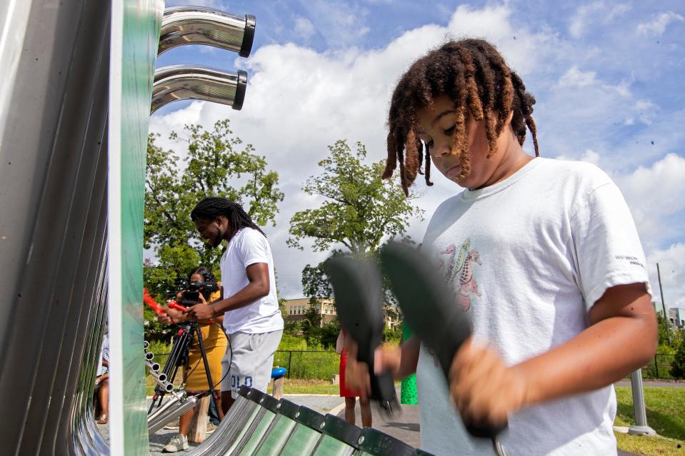 A child plays at the new Red Hills Rhythm musical parklet within Coal Chute Pond Park after its official opening ceremony Wednesday, July 13, 2022 in Tallahasse, Fla. 