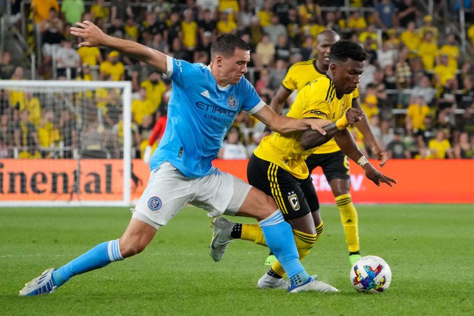 Aug 6, 2022; Columbus, Ohio, USA; Columbus Crew midfielder Luis Diaz (12) fights for a ball with New York City defender Malte Amundsen (12) during the second half of the MLS game at Lower.com Field. The Crew won 3-2. Mandatory Credit: Adam Cairns-The Columbus Dispatch