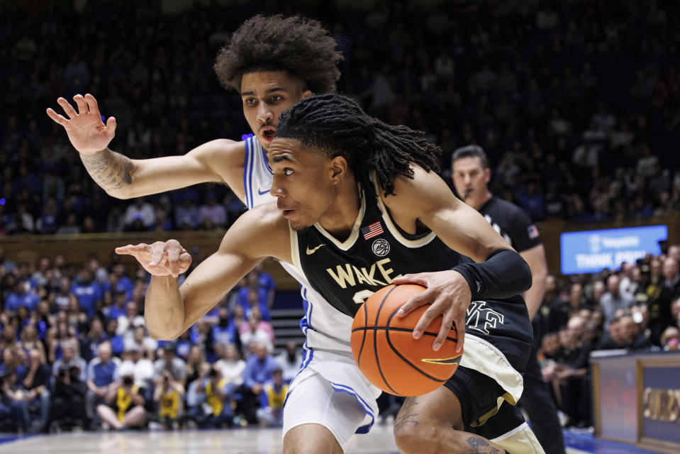 Wake Forest's Hunter Sallis, bottom, handles the ball as Duke's Tyrese Proctor, top, defends during the first half of an NCAA college basketball game in Durham, N.C., Monday, Feb. 12, 2024. (AP Photo/Ben McKeown)