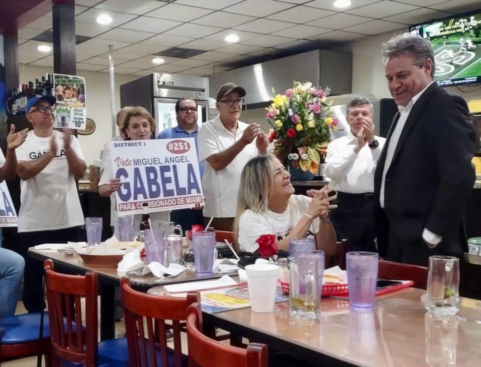 Miguel Angel Gabela, far right, celebrates the results of the city of Miami elections on Tuesday, Nov. 7, 2023, at El Caribe Restaurant in Allapattah. Gabela will face incumbent Alex Diaz de la Portilla in the Nov. 21 runoff election.