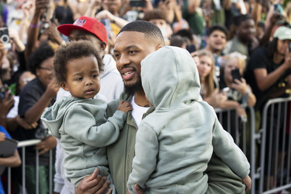 MILWAUKEE, WISCONSIN - SEPTEMBER 30: Damian Lillard walks with his kids during a welcome rally at Fiserv Forum on September 30, 2023 in Milwaukee, Wisconsin. NOTE TO USER: User expressly acknowledges and agrees that, by downloading and or using this photograph, User is consenting to the terms and conditions of the Getty Images License Agreement. (Photo by Patrick McDermott/Getty Images)
