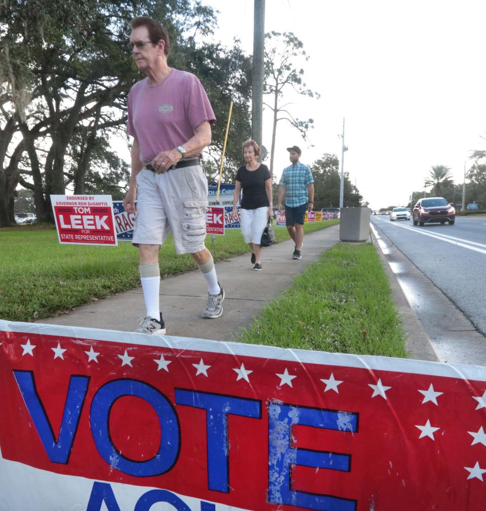 Voters walk to cast their votes in the 2022 midterm election on Tuesday at the Beville Road Church of Christ in Daytona Beach.