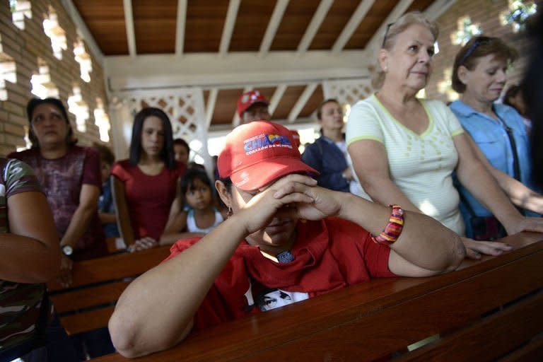 Supporters of Venezuelan President Hugo Chavez pray at the chapel inside the Military Hospital in Caracas, March 5, 2013. Venezuela has plunged deeper into an uncertain future after the cancer-stricken president took a turn for the worse, hit by a severe infection and breathing problems