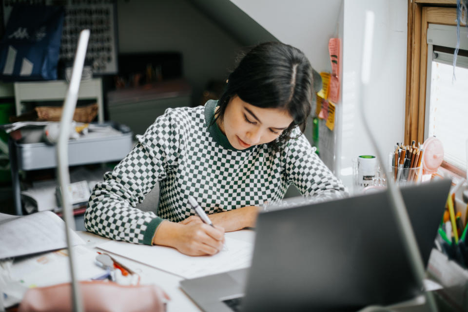 a person writing something down at their desk