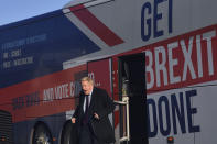 Britain's Prime Minister Boris Johnson alights the 'battle bus' as he arrives for a General Election campaign visit to Ferguson's Transport in Washington, England, Monday, Dec. 9, 2019. Britain goes to the polls on Dec. 12. (Ben Stansall/Pool Photo via AP)