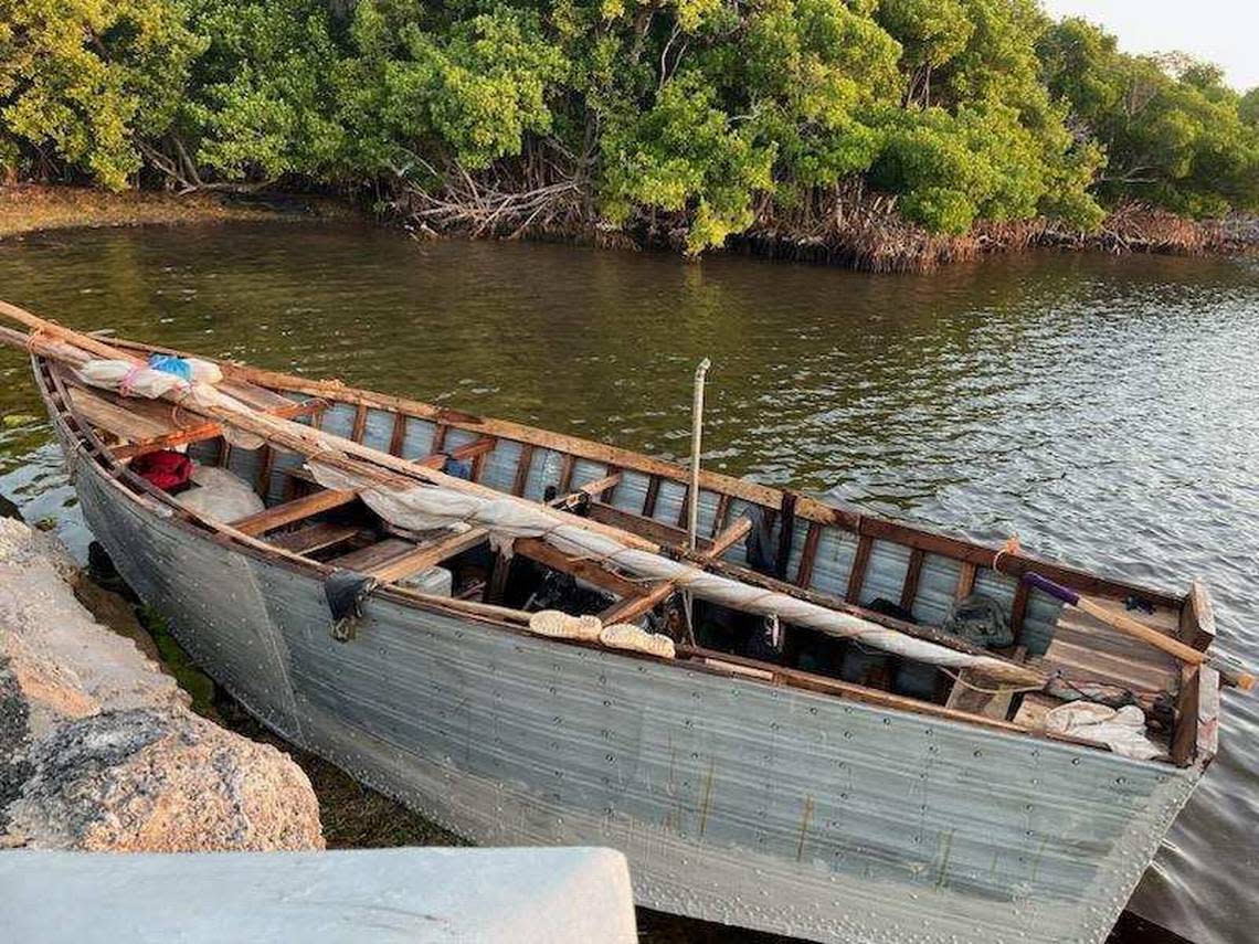 A Cuban migrant boat floats next to a Florida Keys seawall Saturday, Dec. 31, 2022. The U.S. Border Patrol said 88 people from Cuba arrived in the Keys since the day before. On New Year’s Day, several other migrant groups arrived in the island chain.