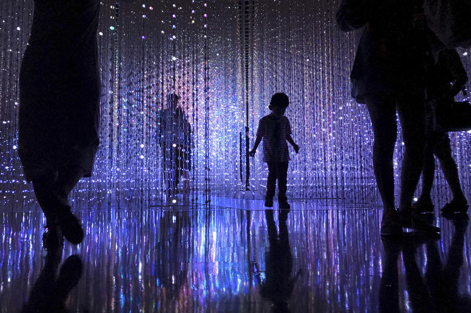 Silhoutted boy at art installation