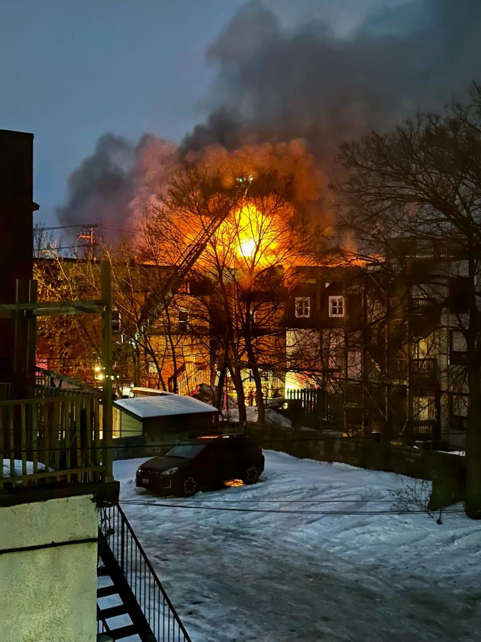 Ottawa firefighters at a burning building at the corner of Sweetland Avenue and Osgoode Street in Sandy Hill Feb. 1, 2024.