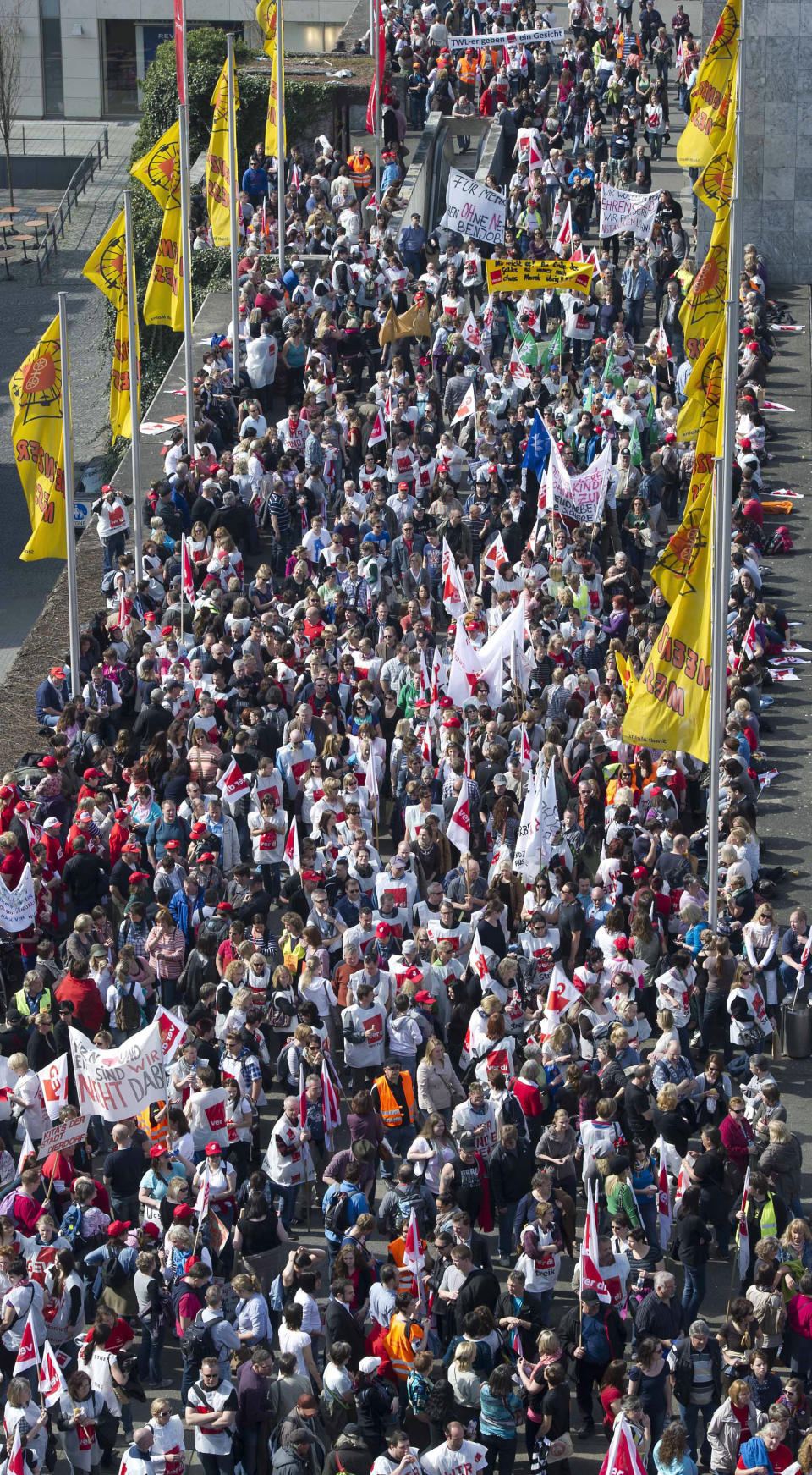 FILE - In this March 27, 2012 file photo public employees demonstrate for higher salaries in Mainz, central Germany. Some 2 million German public-sector employees are to get a pay rise totaling 6.3 percent over two years, employers and a union said Saturday, March 31, 2012 after marathon talks that followed a series of walkouts in recent weeks. The hard-fought agreement banishes the ver.di union's threat to ballot members on an all-out strike campaign had a deal not been reached. (AP Photo/dapd/ Torsten Silz, File)